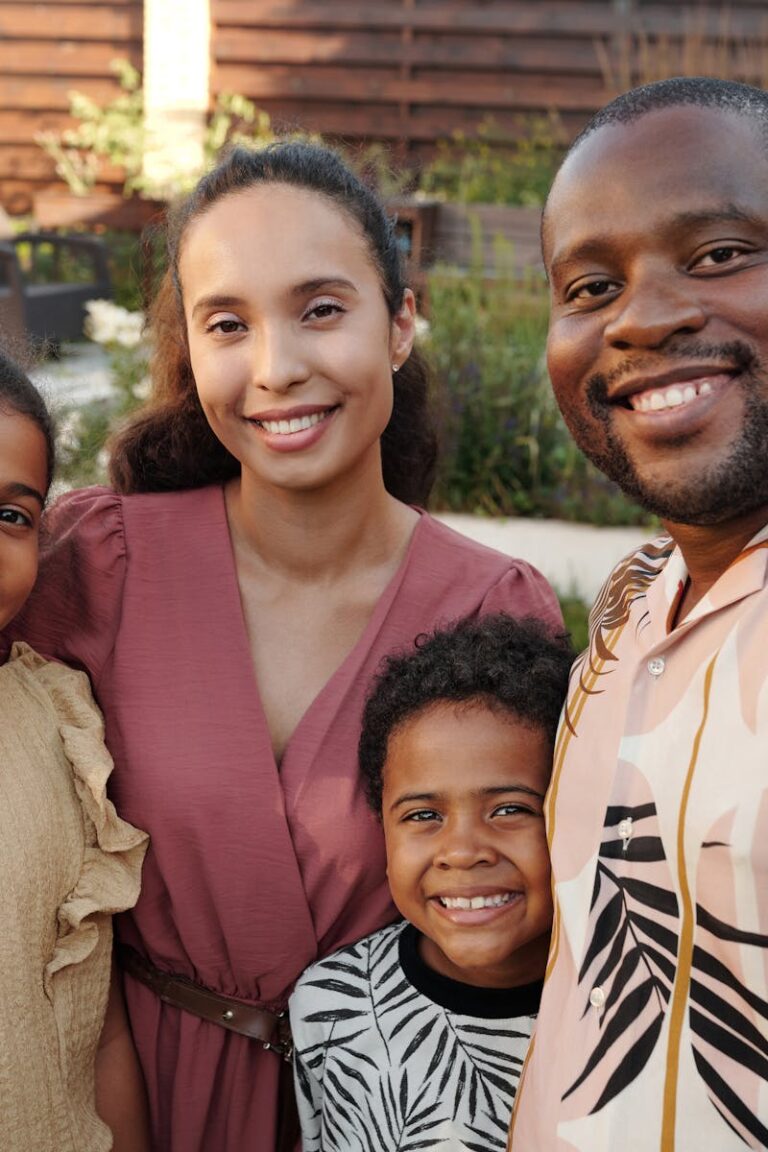 Smiling multicultural family enjoying time together outdoors in their garden.